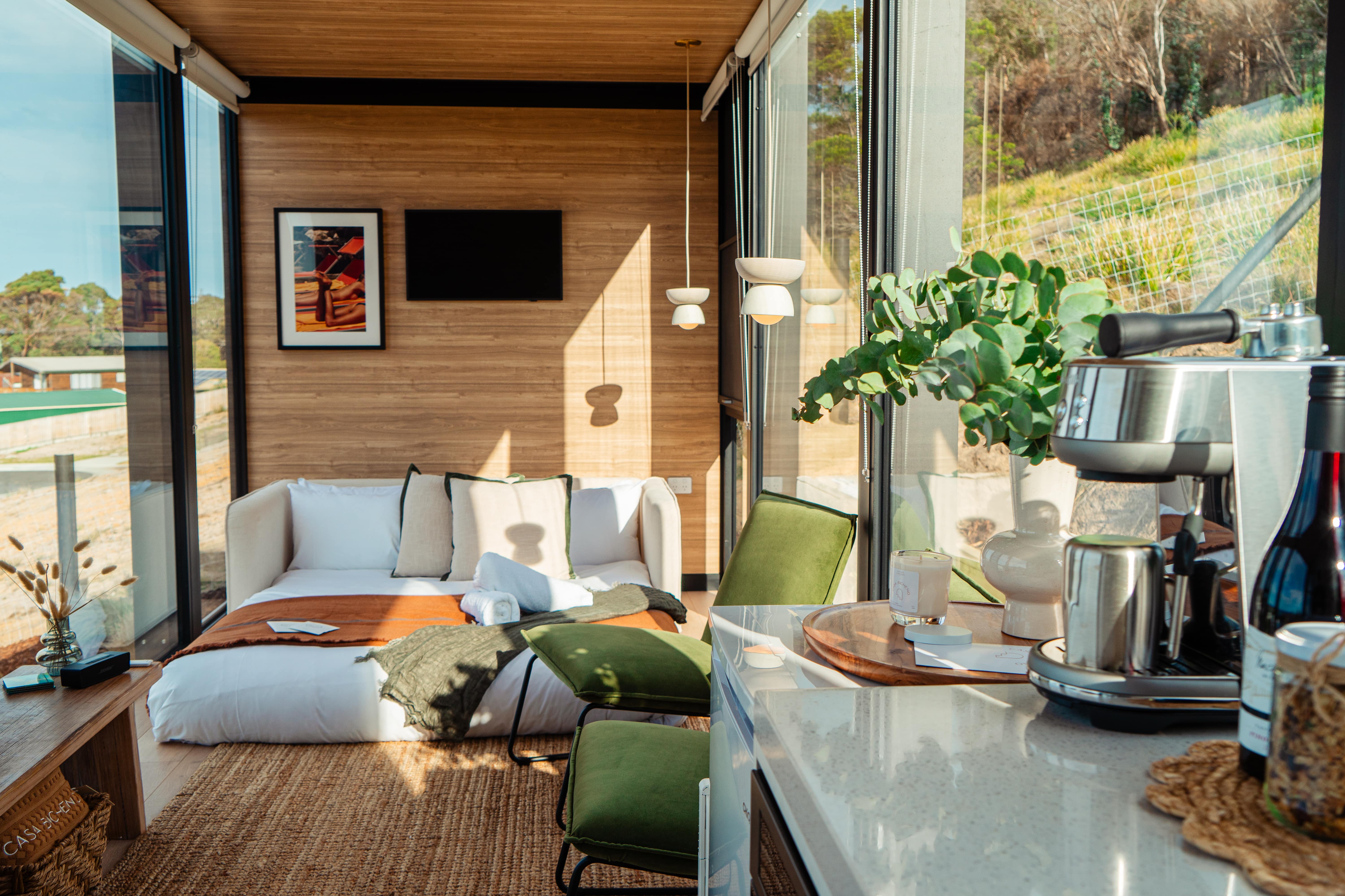 Modern tiny house with glass windows in natural setting